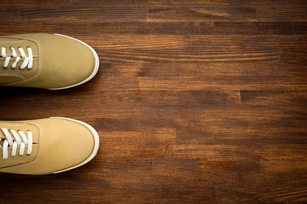 Trevelaing sneakers on wooden background — Stock Photo, Image