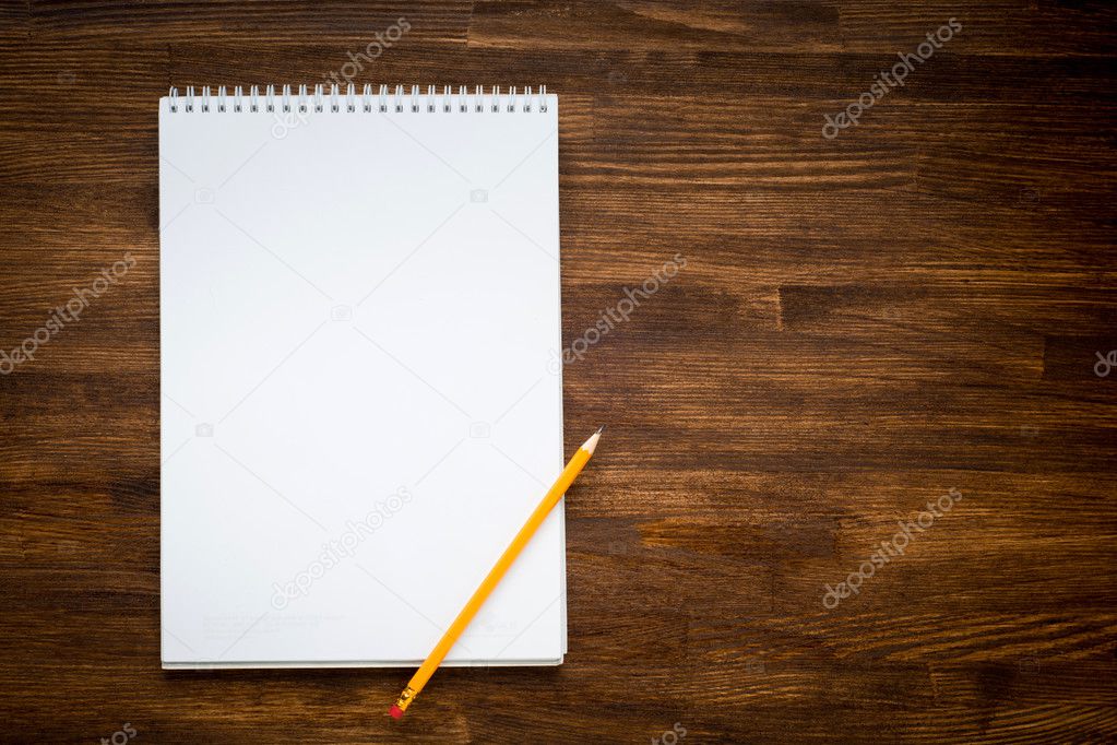 notebook with pencile on a wooden