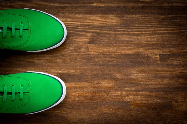 Outfit of traveler, student, teenager, young woman or guy. Colorful sneakers on wooden background. — Stock Photo, Image