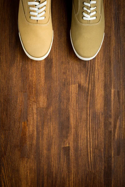 Trevelaing sneakers on wooden background — Stock Photo, Image