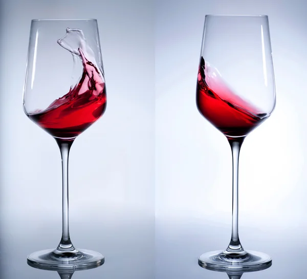 Vino rosso che spruzza nel vetro elegante. — Foto Stock