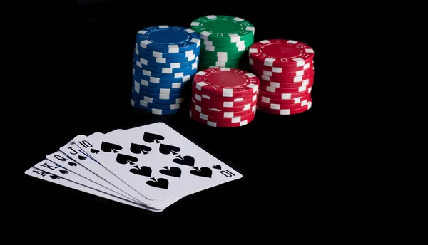 Flash royal on black table with chips — Stock Photo, Image