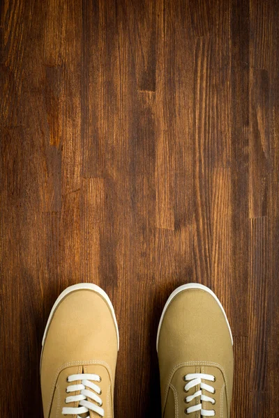 Trevelaing sneakers on wooden background — Stock Photo, Image