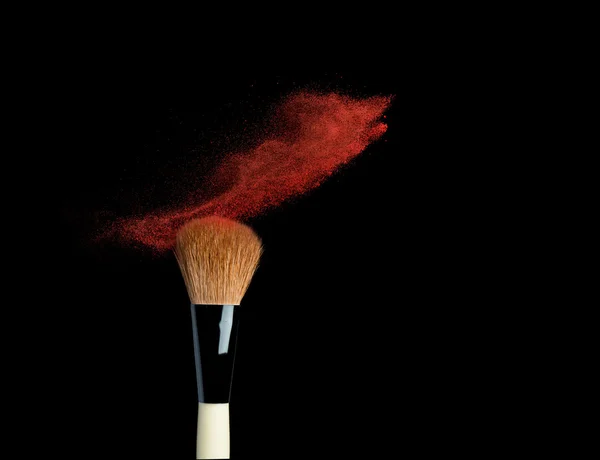 Powderbrush on black background with blue powder splash – stockfoto