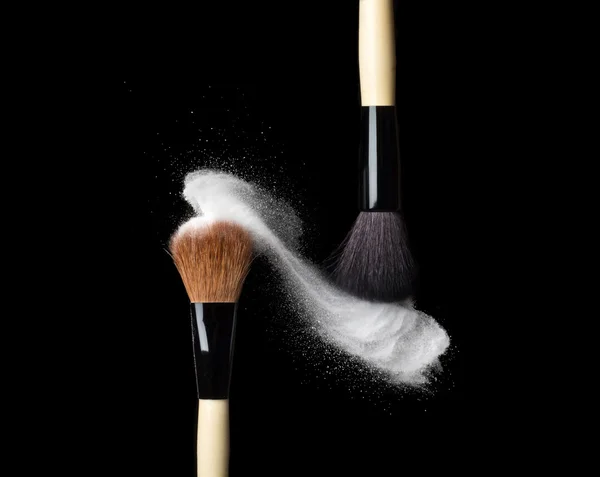 Powderbrush on black background with blue powder splash — Stock Photo, Image
