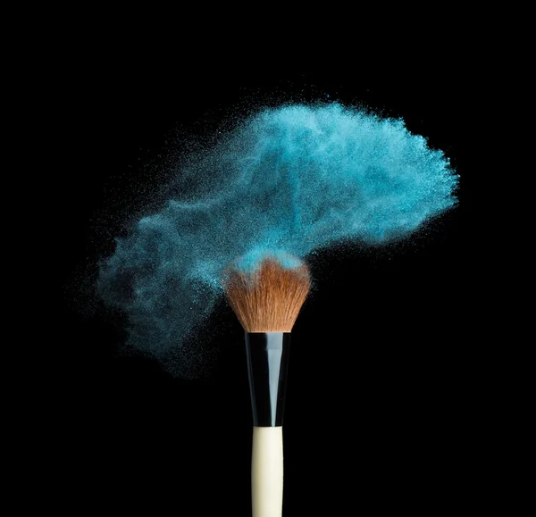 Isolated blue make-up powder with brush on black background — Foto de Stock