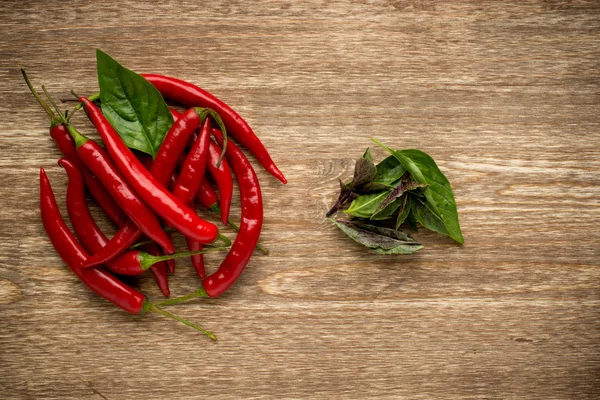 Herbs and spices. basil, red pepper on a wooden background. — Stok fotoğraf