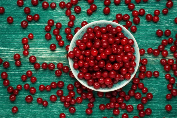 Ripe cherry in a vintage bowl on wooden background — ストック写真