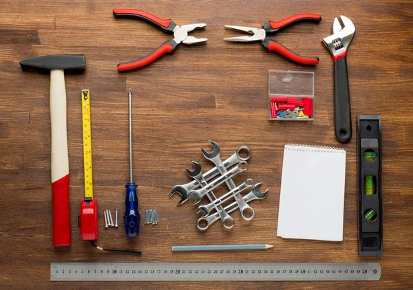 Set of tools over a wood panel with space for text — Stock Photo, Image