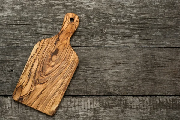 Wood chopping board on wooden background — Stock Photo, Image