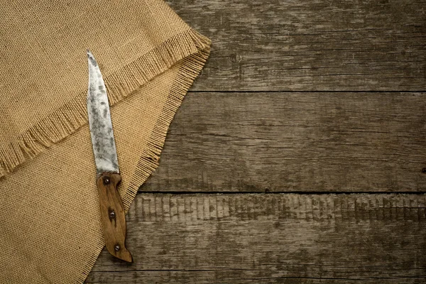 Vintage knife on rustic background with burlap. — Stock Photo, Image