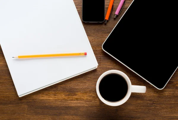 Tablet computer with stickers,cup of coffee and on the wooden table — Stock Photo, Image