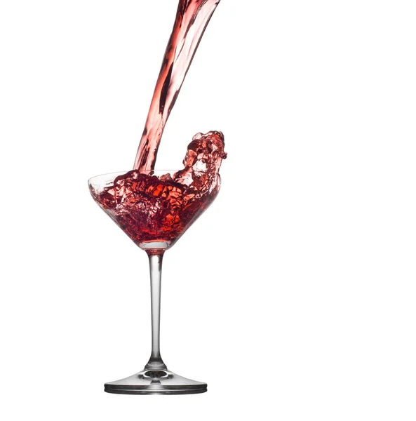 Red cocktail splashing from glass isolated on white background — Stock Photo, Image
