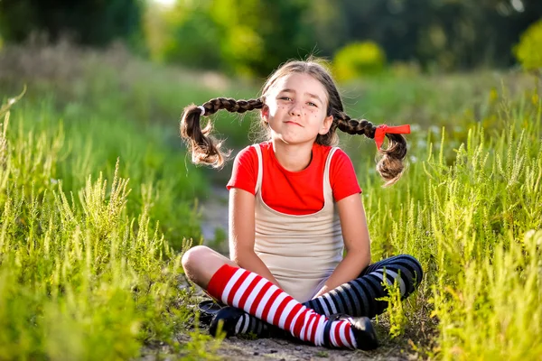 Chica con coletas imagina el verano en la naturaleza — Foto de Stock