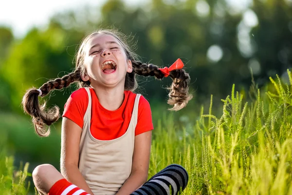 Naughty girl with pigtails, opens his mouth and shouts — Stock Photo, Image