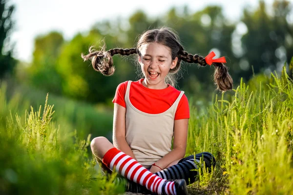 Naughty girl with pigtails, opens his mouth and shouts — Stock Photo, Image