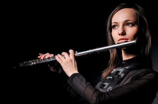 a young girl playing the flute