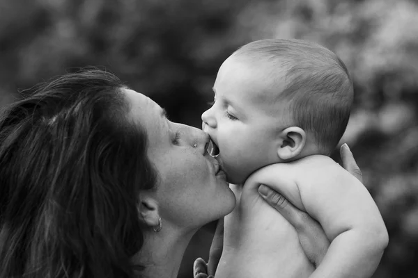 Mother embraces and kisses his little son — Stock Photo, Image