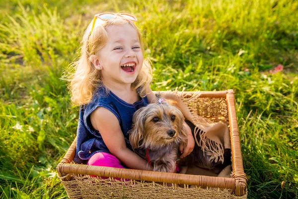 Köpeğini bir hasır sepet içinde oturan kızla mutlu çocuk — Stok fotoğraf