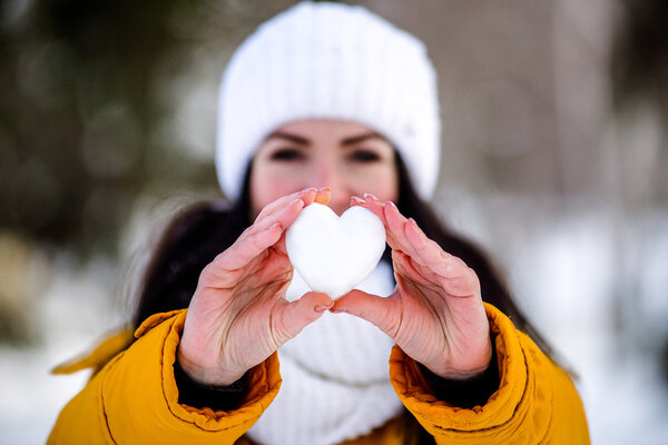 Heart of snow in the hands of a girl