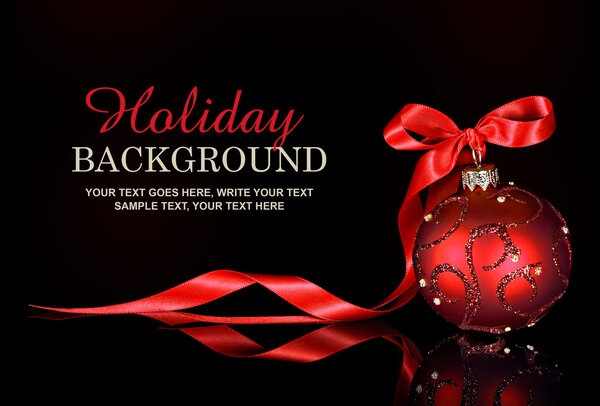 Christmas background with a red ornament and ribbon on a black background — Stock Photo, Image