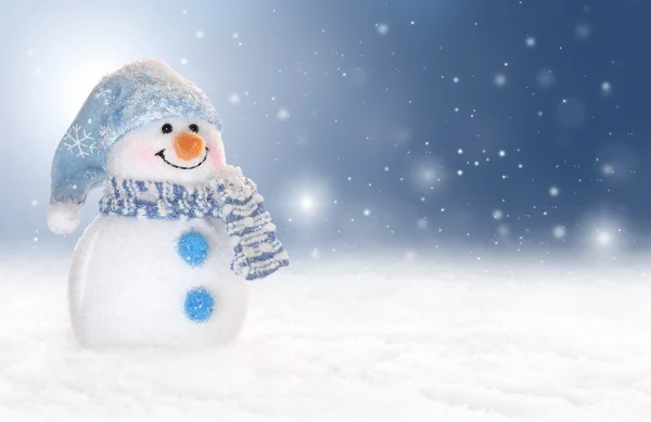 Holiday or winter background with a cute, cheerful snowman in snow — Stock Photo, Image