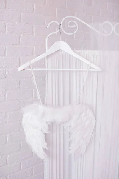 The wings of an angel on a hanger. The white feathers.
