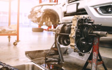 Servis merkezinde, arka planda hafif odaklı ve ışığın üzerinde olan araba motorunun yakın plan ayrıntıları