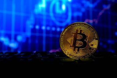Bitcoin altın sikke klavye ve grafikte yumuşak odaklı ve arka planda ışık üzerinde. şifreleme para birimi kavramı.