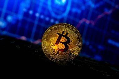 Bitcoin altın sikke klavye ve grafikte yumuşak odaklı ve arka planda ışık üzerinde. şifreleme para birimi kavramı.