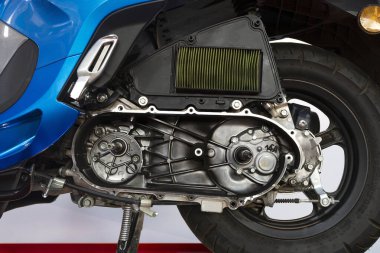 CVT kapağı kaldırılmış mavi otomatik scooter motoru, bakım için dahili iletim bileşenleri ve hava filtresi gösteriliyor.