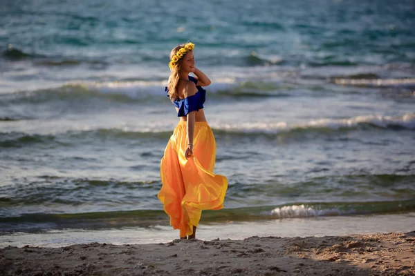 年轻的金发姑娘穿着黄色的裙子在海滨 — 图库照片