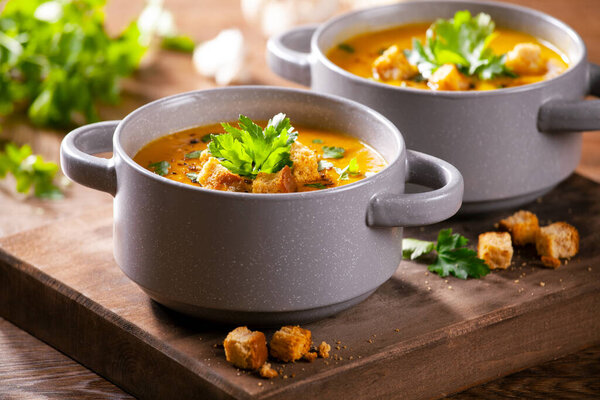 Bowls of homemade soup with organic potatoes and carrots