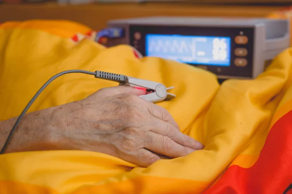 Patient monitored by pulse oximeter Stock Image