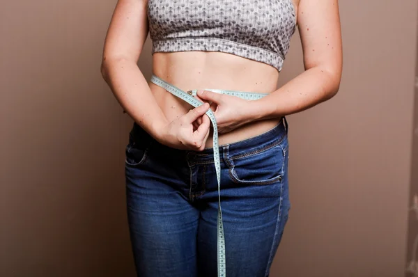 Young girl shows her obesity — Stock Photo, Image