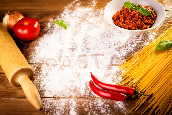 Ingredients for spaghetti on a wooden table — Stock Photo, Image