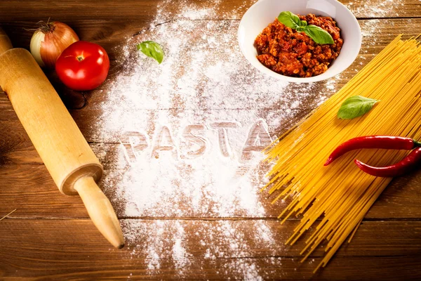 Ingredients for spaghetti on a wooden table — Stock Photo, Image