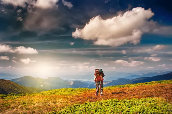 Mulher viajante com mochila caminhadas em montanhas — Fotografia de Stock