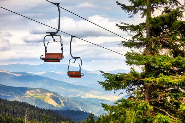 Chairlift going over trees in the summer on Mountain. Carpathian — Stock Photo, Image