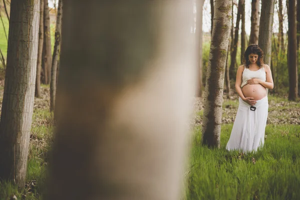 Pregnant woman in forest — Stock Photo, Image