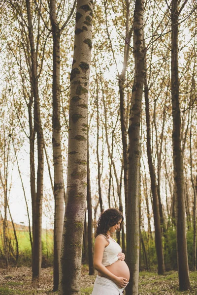 Pregnant woman in forest — Stock Photo, Image