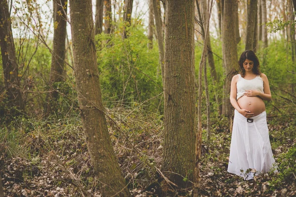 Pregnant woman in forest — Stock Photo, Image