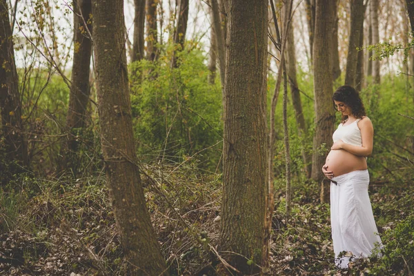 Pregnant woman in forest — Stock Photo, Image