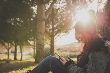 Genç kız sonbahar Park müzik dinlemek