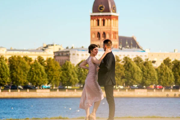 Young couple dancing tango against the old city background. Travel and lifestyle concepts.