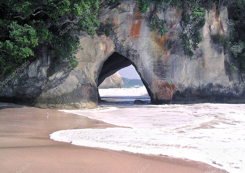 Secret Paradise Beach Cave. Location is a remote beach among lime stone rocks called Cathedral Cove in New Zeeland