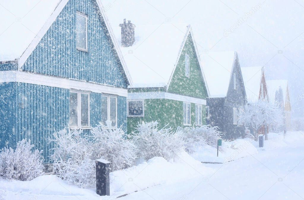 Houses in extremely cold, snowy and frosty winter storm conditions.