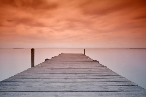 Wooden pier at sunset — Stock Photo, Image