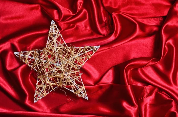 Christmas tree star on red satin — Stock Photo, Image