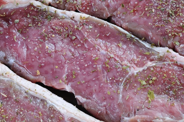 Close-up of raw spiced red meat — Stock Photo, Image